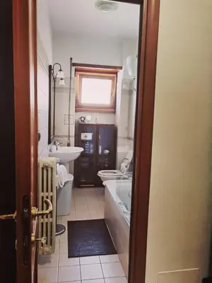 a bathroom with a sink and a tub and a toilet at Appartamento per Turisti e Famiglie Roma in Rome