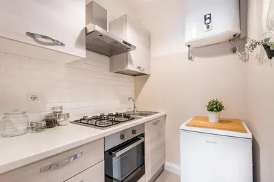 a small kitchen with a stove and a sink at The small nest at Coliseum in Rome
