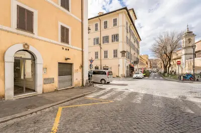 an empty street in a city with buildings at The small nest at Coliseum in Rome