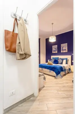 a bedroom with a bed with blue walls at Holiday Homes Rome - Portuense 21 - Family Studio in Rome