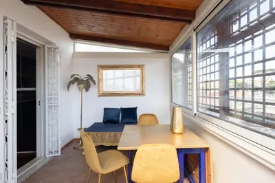 a room with a table and chairs and a bed at New opening San Pietro roof apartament in Rome