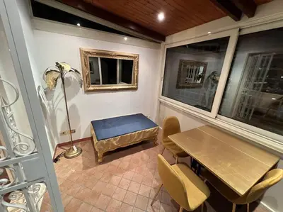 a room with a table and a bench and some windows at New opening San Pietro roof apartament in Rome