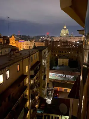 a view of a city at night with a building at New opening San Pietro roof apartament in Rome