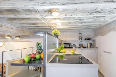 a kitchen with a counter with fruits and vegetables on it at Design apt near Spanish Step in Rome