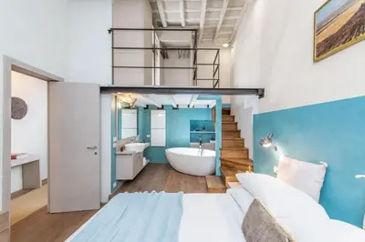 a bathroom with a bed and a tub in a room at Design apt near Spanish Step in Rome