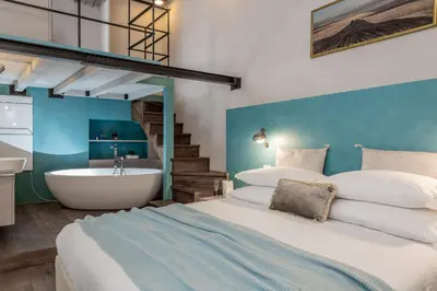 a bedroom with a large bed and a bath tub at Design apt near Spanish Step in Rome