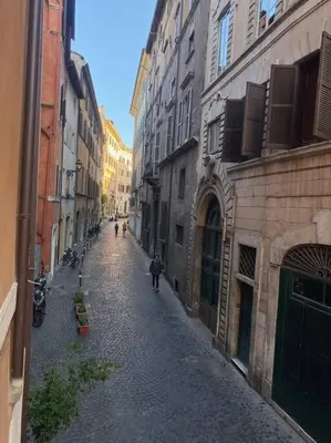 an empty street in an alley between buildings at Casa Uberto in Rome