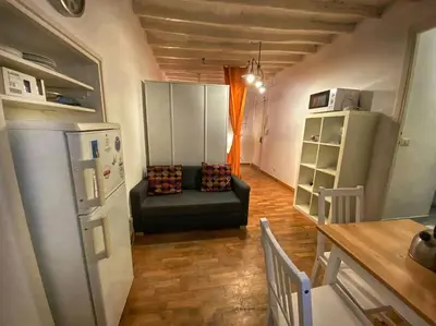a living room with a couch and a refrigerator at Casa Uberto in Rome