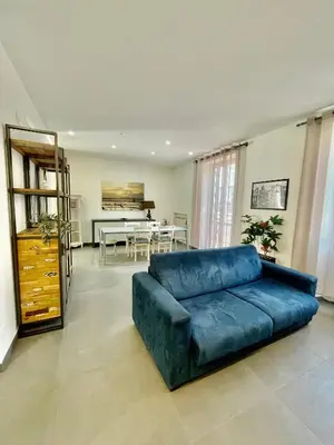 a blue couch in a living room with a table at PRIVATEHOUSEINROME in Rome