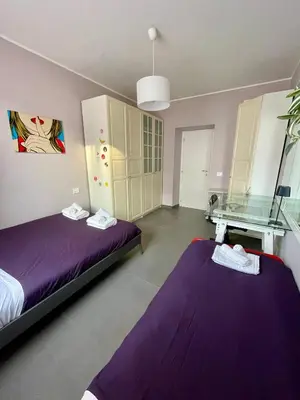 a bedroom with two beds and a glass table at PRIVATEHOUSEINROME in Rome