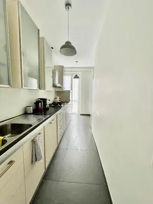 a kitchen with white cabinets and a counter top at PRIVATEHOUSEINROME in Rome