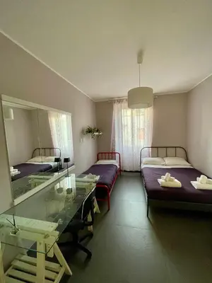 a room with two beds and a glass table at PRIVATEHOUSEINROME in Rome