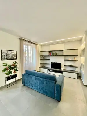 a living room with a blue couch and a television at PRIVATEHOUSEINROME in Rome