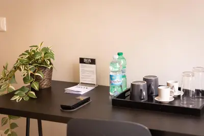 a table with a bottle of water and a cell phone at Iron Cityaus Termini in Rome