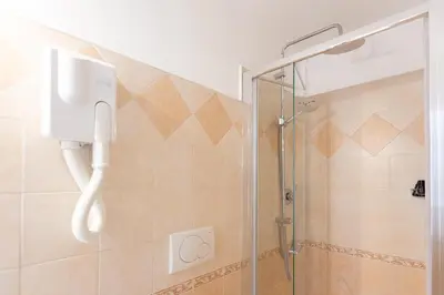 a shower with a phone in a bathroom at Iron Cityaus Termini in Rome