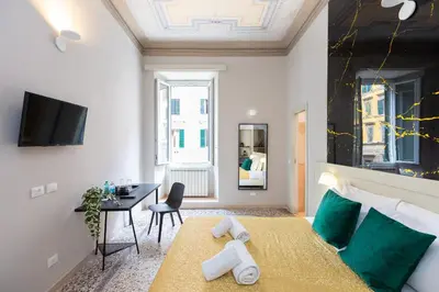 a bedroom with a bed and a desk in a room at Iron Cityaus Termini in Rome
