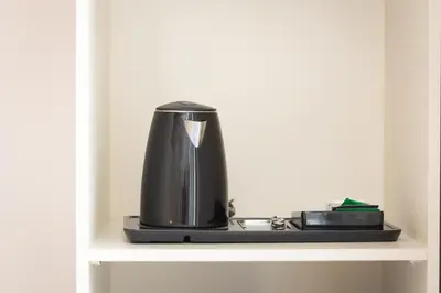 a coffee maker is sitting on a shelf at Iron Cityaus Termini in Rome