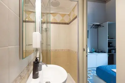 a bathroom with a sink and a shower at Iron Cityaus Termini in Rome