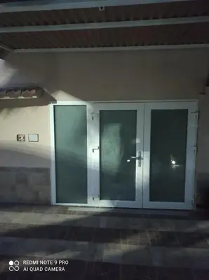 a glass door of a building with a person in it at Casa Mario in Rome