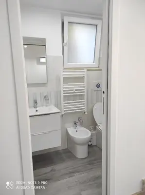 a white bathroom with a sink and a toilet at Casa Mario in Rome
