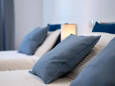 a bedroom with blue pillows on a bed at Anastasio Vatican Rooms G H in Rome