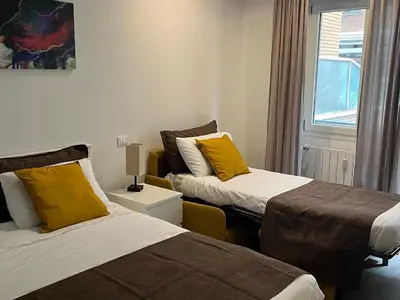 a room with two beds and a window at Anastasio Vatican Rooms G H in Rome