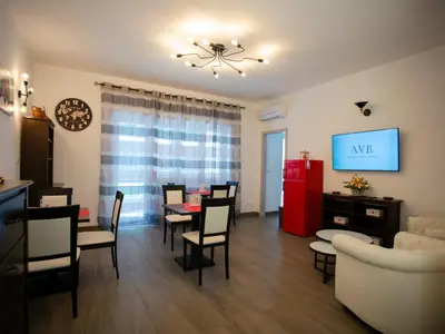 a dining room and living room with a table and chairs at Anastasio Vatican Rooms G H in Rome