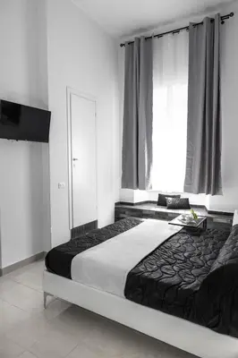 a bedroom with a large bed and a large window at Emperooms Guest House in Rome