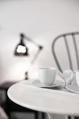 a white table with two cups and spoons on it at Emperooms Guest House in Rome