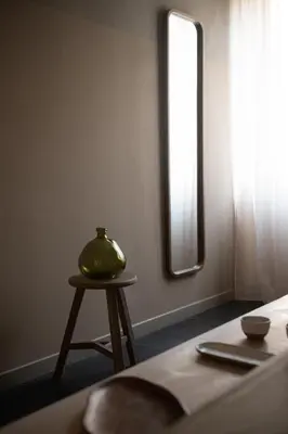 a table with a vase on it next to a window at The Sanctuary Urban Retreat in Rome