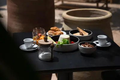 a black table with a tray of food on it at The Sanctuary Urban Retreat in Rome