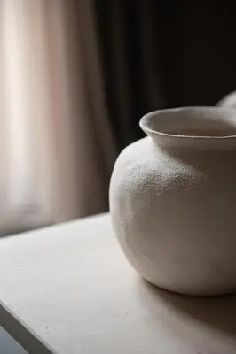 a white vase sitting on top of a table at The Sanctuary Urban Retreat in Rome