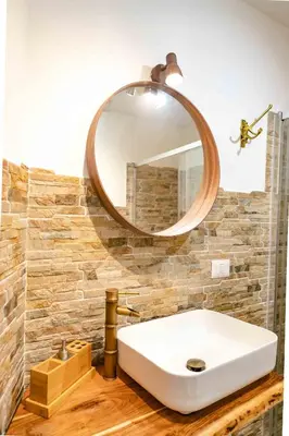 a bathroom with a white sink and a mirror at MyWay Colosseo Apartment in Rome