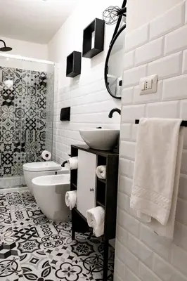 a bathroom with a sink and a tub and a toilet at MyWay Colosseo Apartment in Rome