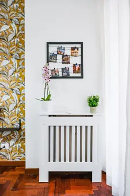 a white console table with a picture on the wall at St. Peter Vatican Home in Rome