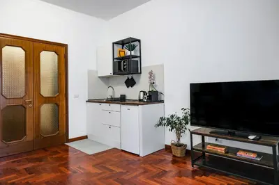 a living room with a flat screen tv next to a door at St. Peter Vatican Home in Rome