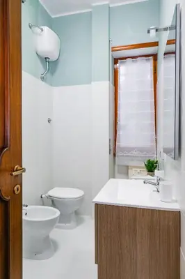 a white bathroom with a toilet and a sink at St. Peter Vatican Home in Rome