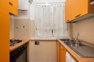 a small kitchen with a sink and a window at Re di Roma - Charme Apartment in Rome