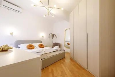 a white bedroom with a bed and a closet at Re di Roma - Charme Apartment in Rome