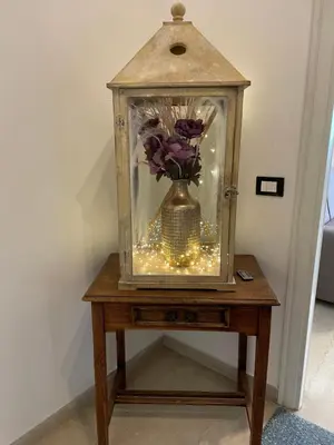 a vase with flowers in a clock on a table at Gregorio VII Vatican House in Rome