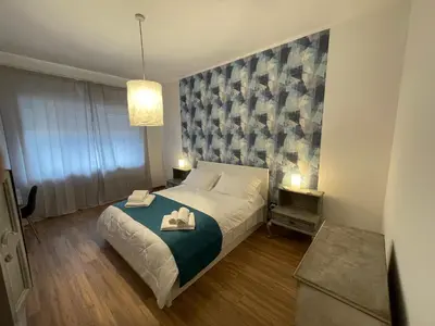 a bedroom with a bed and a painting on the wall at Gregorio VII Vatican House in Rome