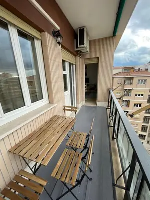 a porch with two benches on a balcony at Gregorio VII Vatican House in Rome