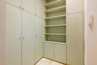 a white walk in closet with white cabinets at VRhome in Rome