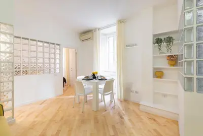 a white dining room with a white table and chairs at VRhome in Rome