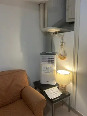 a room with a chair and a table with a lamp at Home in Trastevere Testaccio in Rome