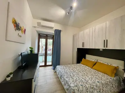 a bedroom with a bed and a television in it at ZAMA HOME in Rome