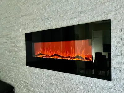 a fireplace built into a brick wall with a fire in it at ZAMA HOME in Rome
