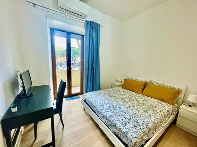 a bedroom with a desk and a bed and a desk and a computer at ZAMA HOME in Rome