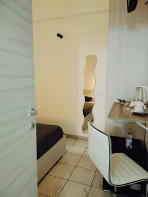 a room with a bed and a chair in it at Bosuites Rome in Rome
