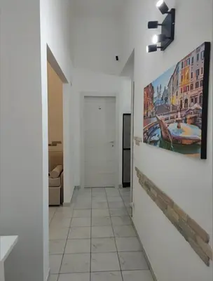 a hallway with a painting on the wall at Bosuites Rome in Rome